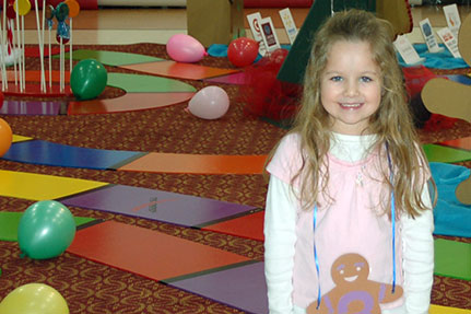Little Girl Posing for Picture in Candy Land